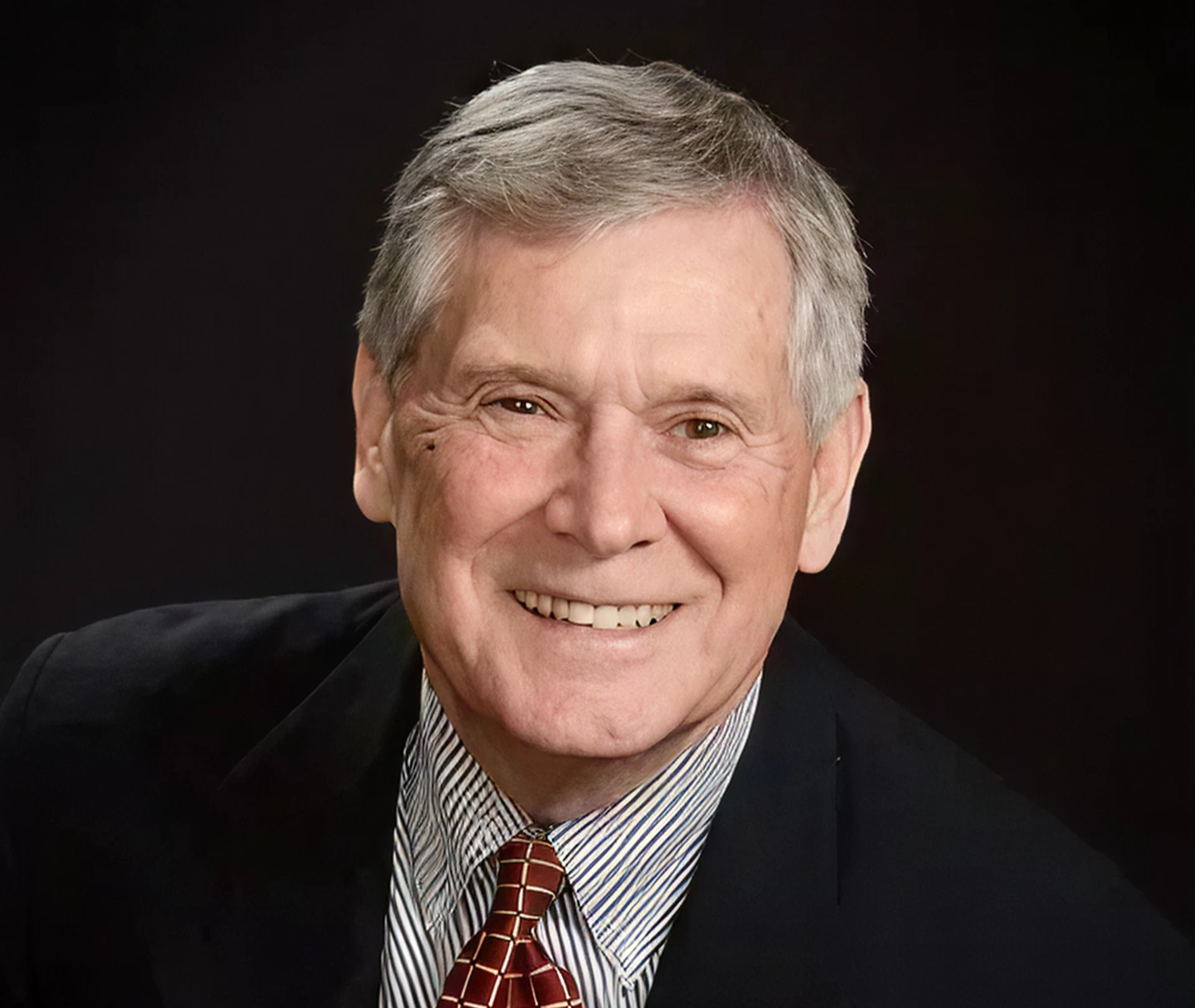 Elderly man with grey hair smiling