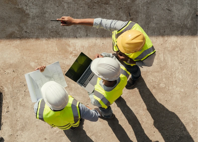 Engineers discussing project with laptop